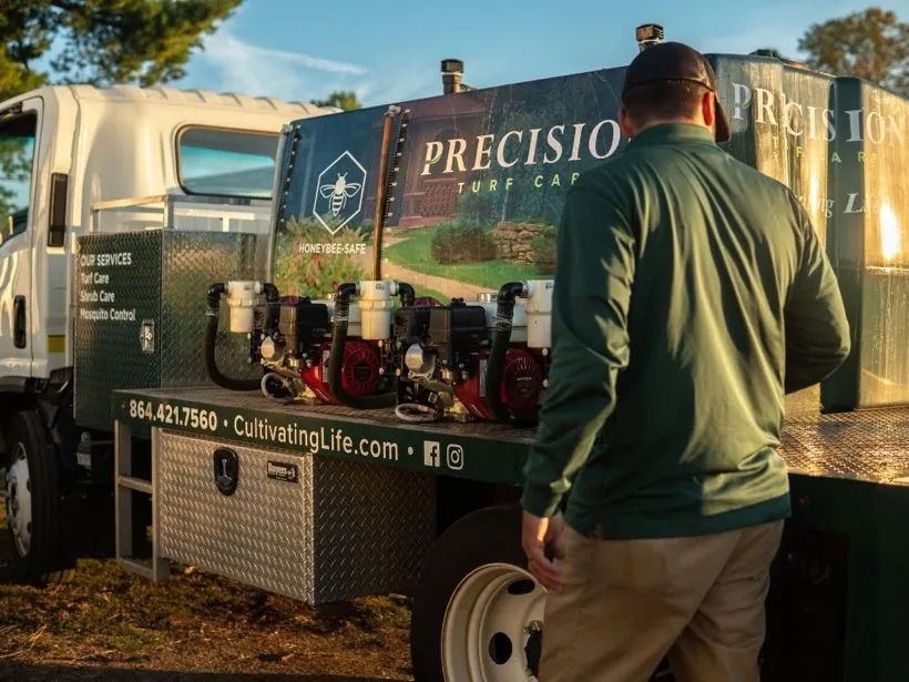 Precision Landscape Management service truck and technician